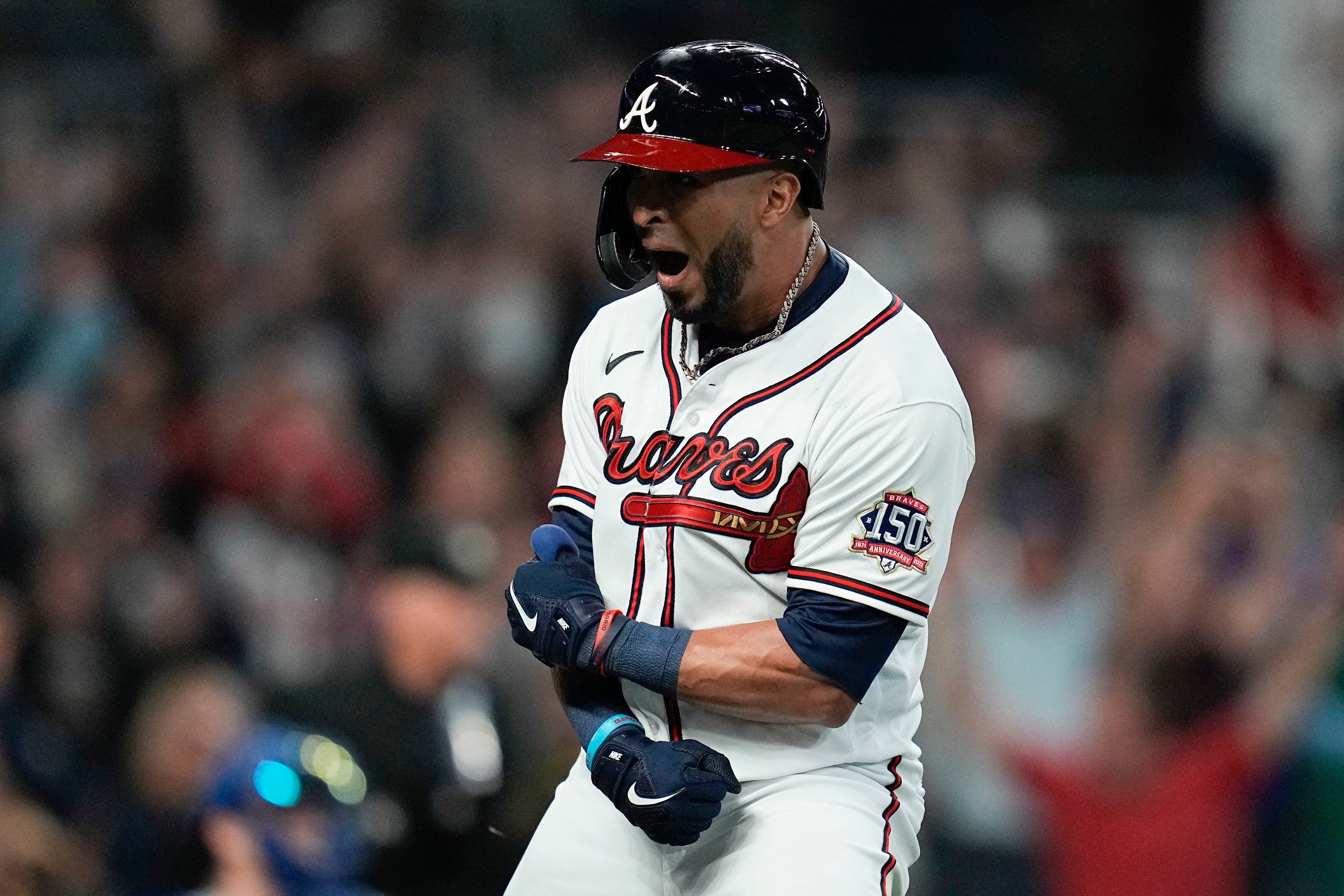 Atlanta Braves' Freddie Freeman (5) turns back with a smile as he heads to  the dugout after hitting a two-run home run in the first inning of a  baseball game against the