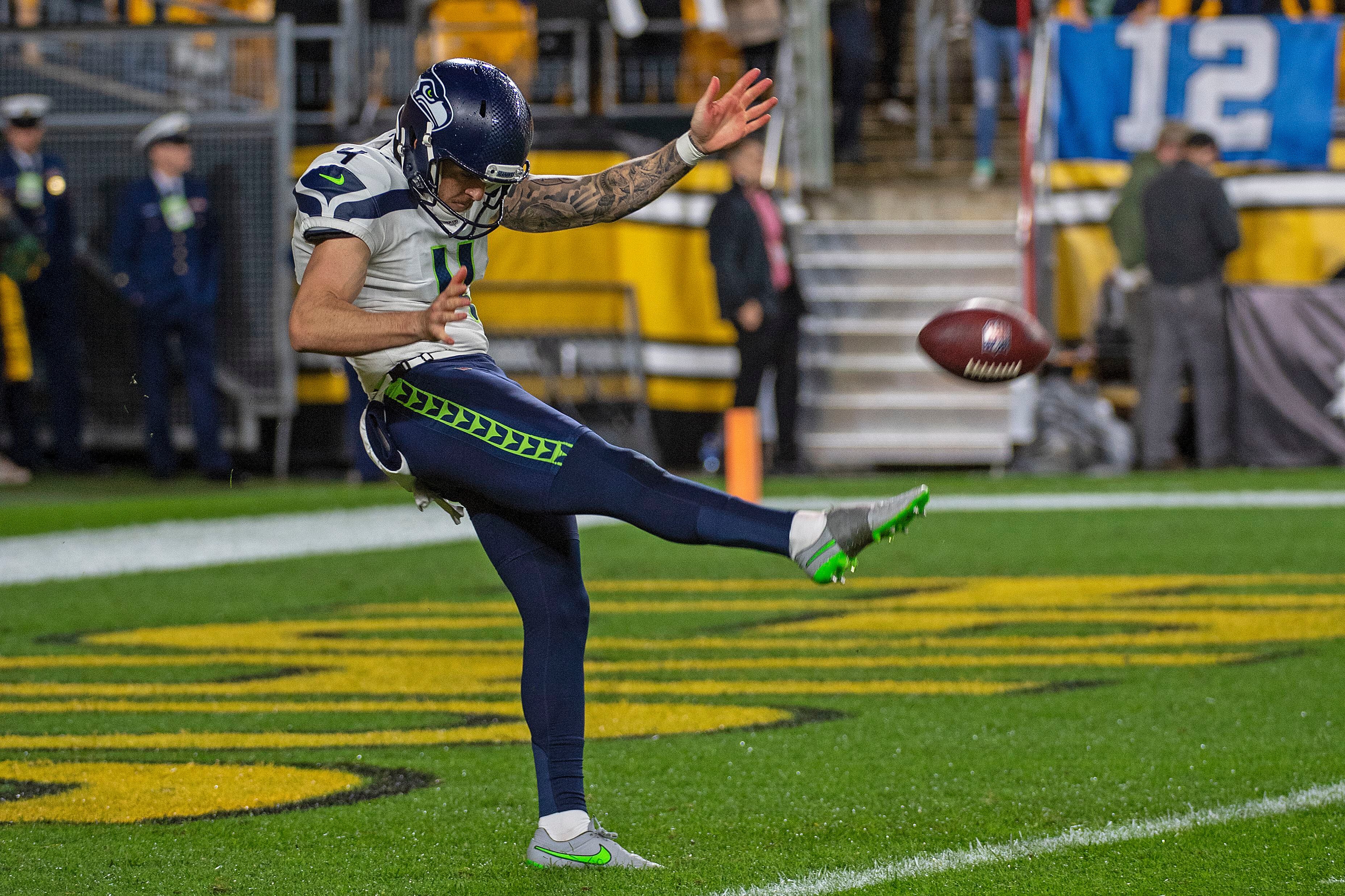 Seattle Seahawks punter Michael Dickson (4) runs off the field at the end  of the first half of an NFL football game against the Seattle Seahawks in  Detroit, Michigan USA, on Sunday