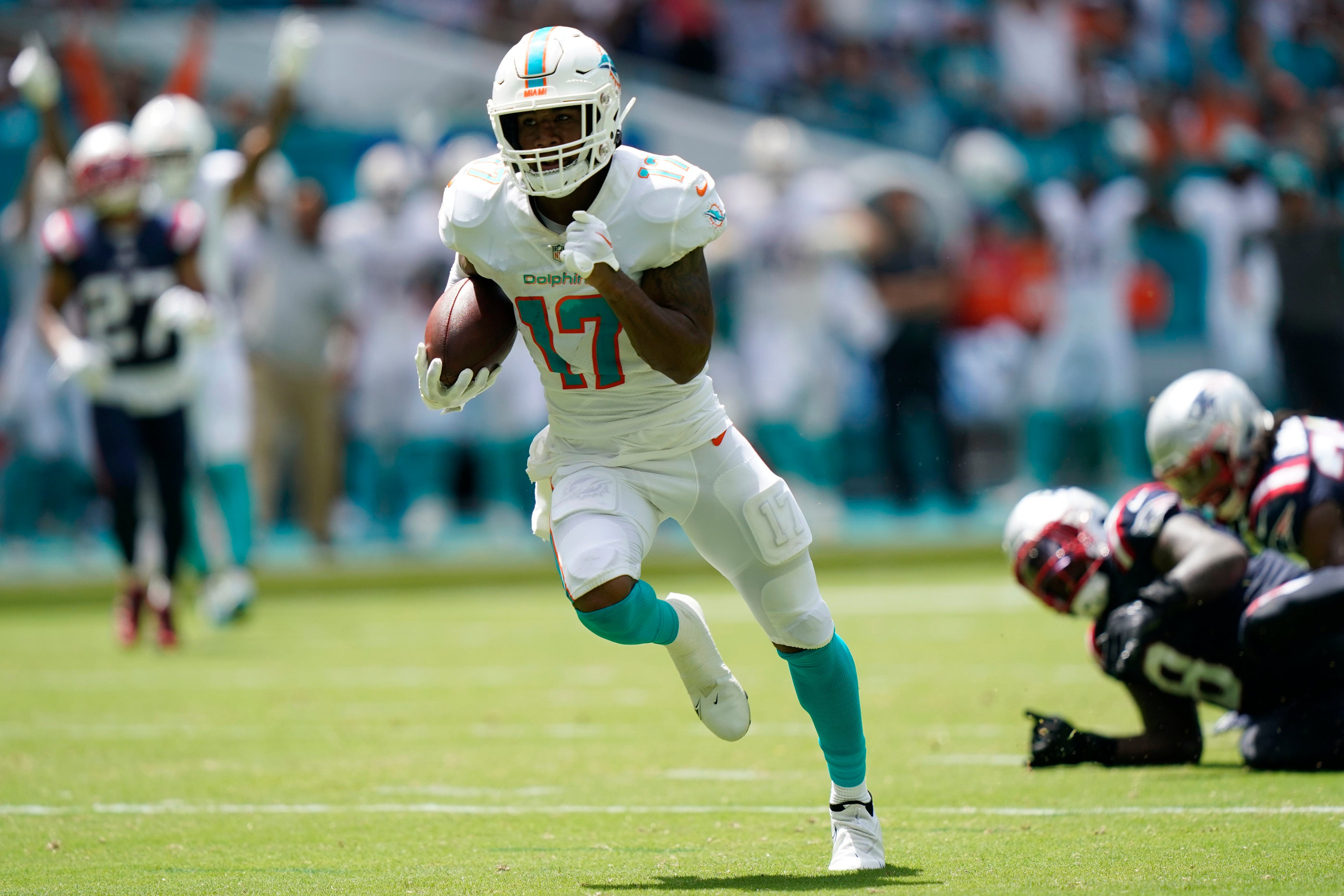 Miami Dolphins safety Jevon Holland (8) enters the field through the smoke  before an NFL football game against the Buffalo Bills, Sunday, Sept. 25,  2022 in Miami Gardens, Fla. The Dolphins defeat