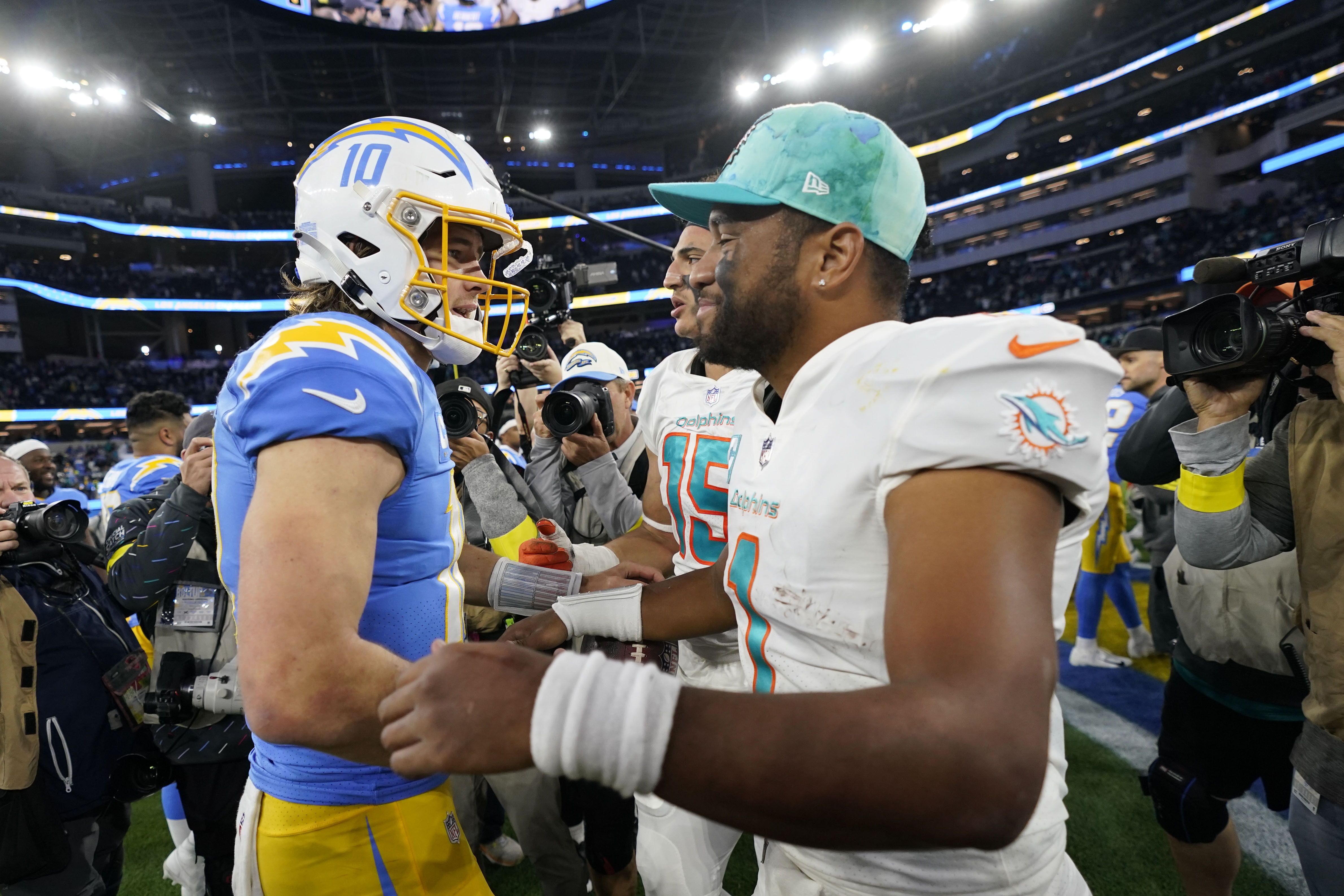 Miami Dolphins wide receiver Tyreek Hill, right, runs past Los Angeles  Chargers safety Alohi Gilman during the second half of an NFL football game  Sunday, Sept. 10, 2023, in Inglewood, Calif. (AP