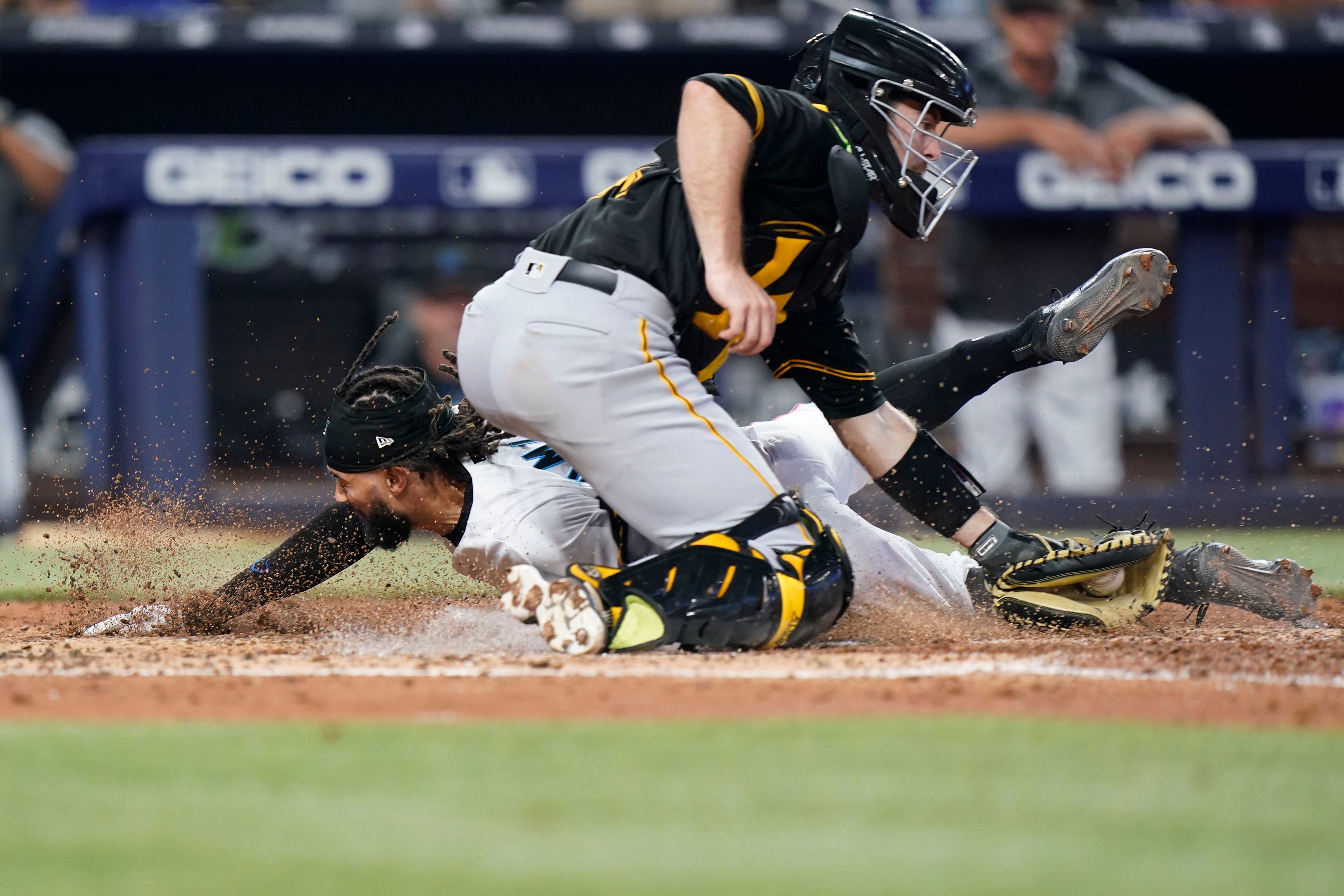 Pittsburgh Pirates' Yoshi Tsutsugo, left, tips his helmet as he