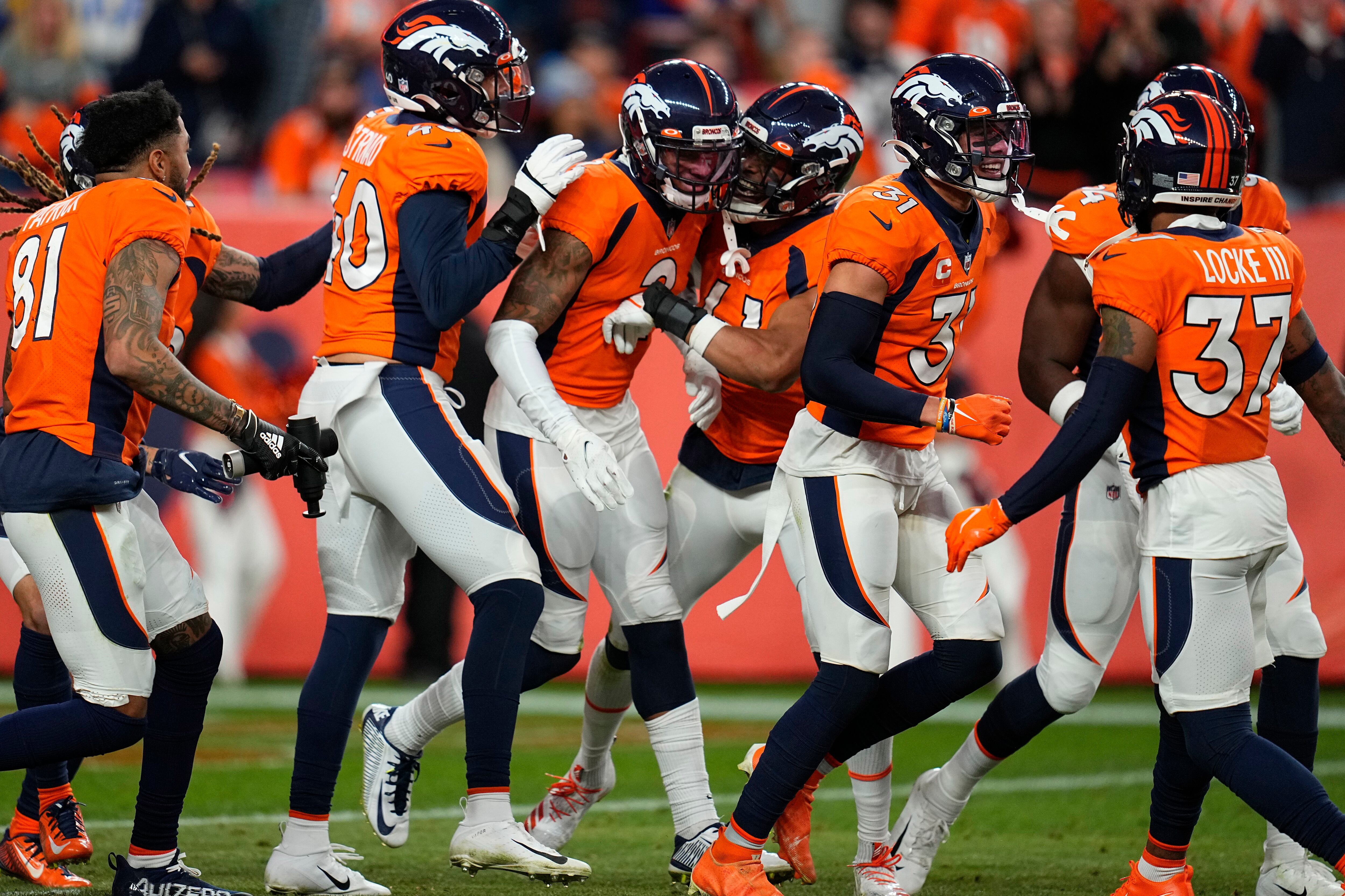 Denver Broncos running back Javonte Williams (33) celebrates his touchdown  run against the Los Angeles Chargers during the first half of an NFL  football game, Sunday, Nov. 28, 2021, in Denver. (AP