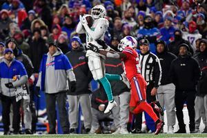 Miami Dolphins wide receiver Jaylen Waddle (17) catches a pass Buffalo  Bills cornerback Tre'Davious White (27) during second quarter of an NFL  football game at Highmark Stadium on Saturday, Dec. 17, 2022