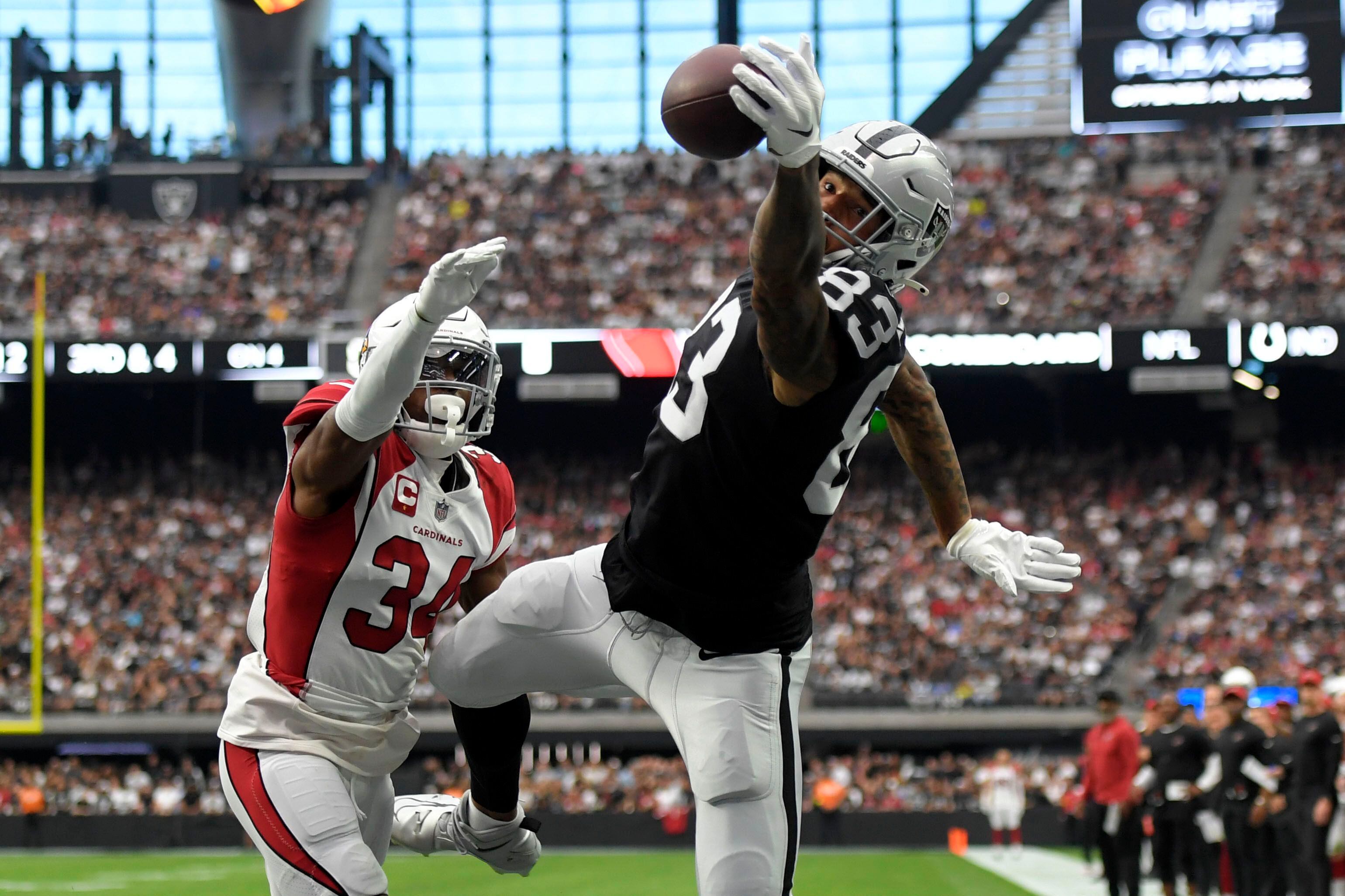 Las Vegas Raiders quarterback Derek Carr (4) is sacked by Arizona Cardinals  defensive end J.J. Watt (99) during the first half of an NFL football game  Sunday, Sept. 18, 2022, in Las