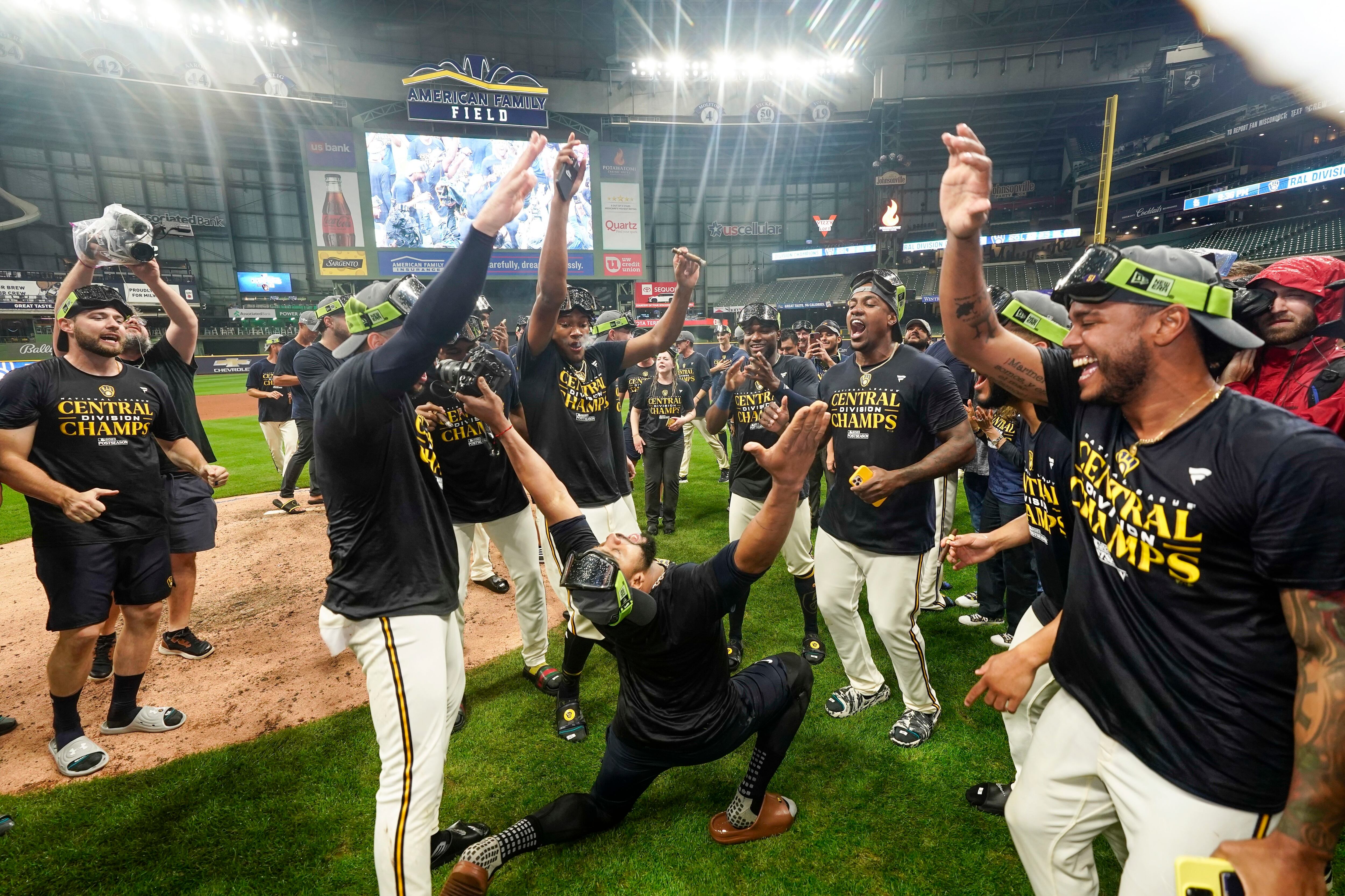 Milwaukee Brewers' owner Mark Attanasio and wife Debbie celebrate with  broadcaster Bob Uecker after clinching the National League Central Division  after a baseball game against the St. Louis Cardinals Tuesday, Sept. 26