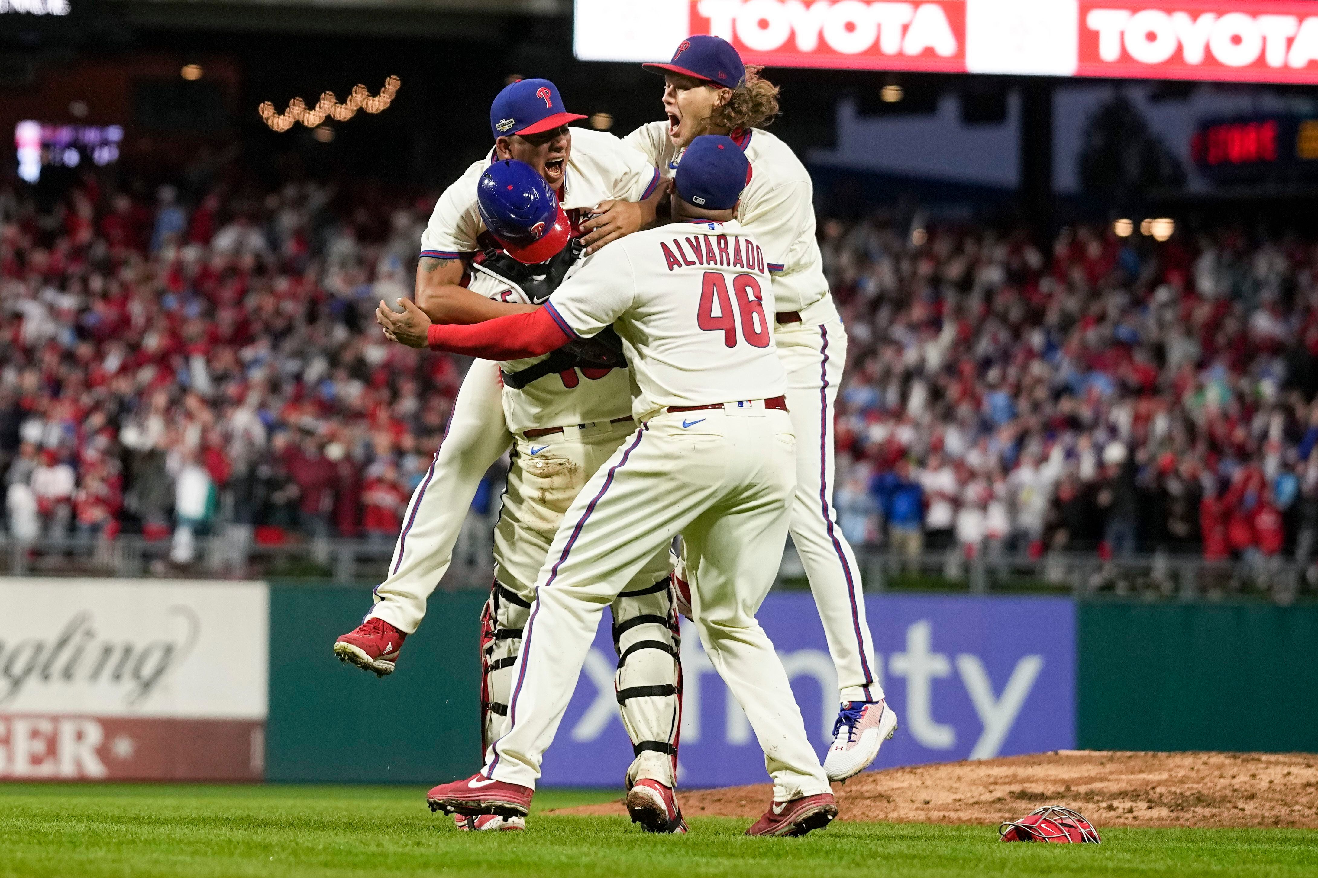 Philadelphia Phillies starting pitcher Ranger Suarez and catcher J.T.  Realmuto celebrate after winning the baseball NL Championship Series  against the San Diego Padres on Sunday, Oct. 23, 2022, in Philadelphia. (AP  Photo/Brynn