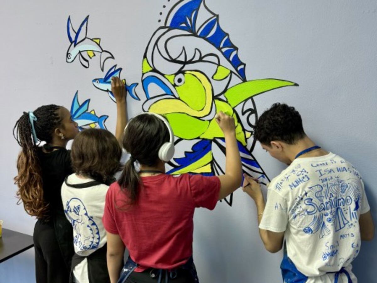 Cutler Bay Senior High students paint murals in the school's hallways.