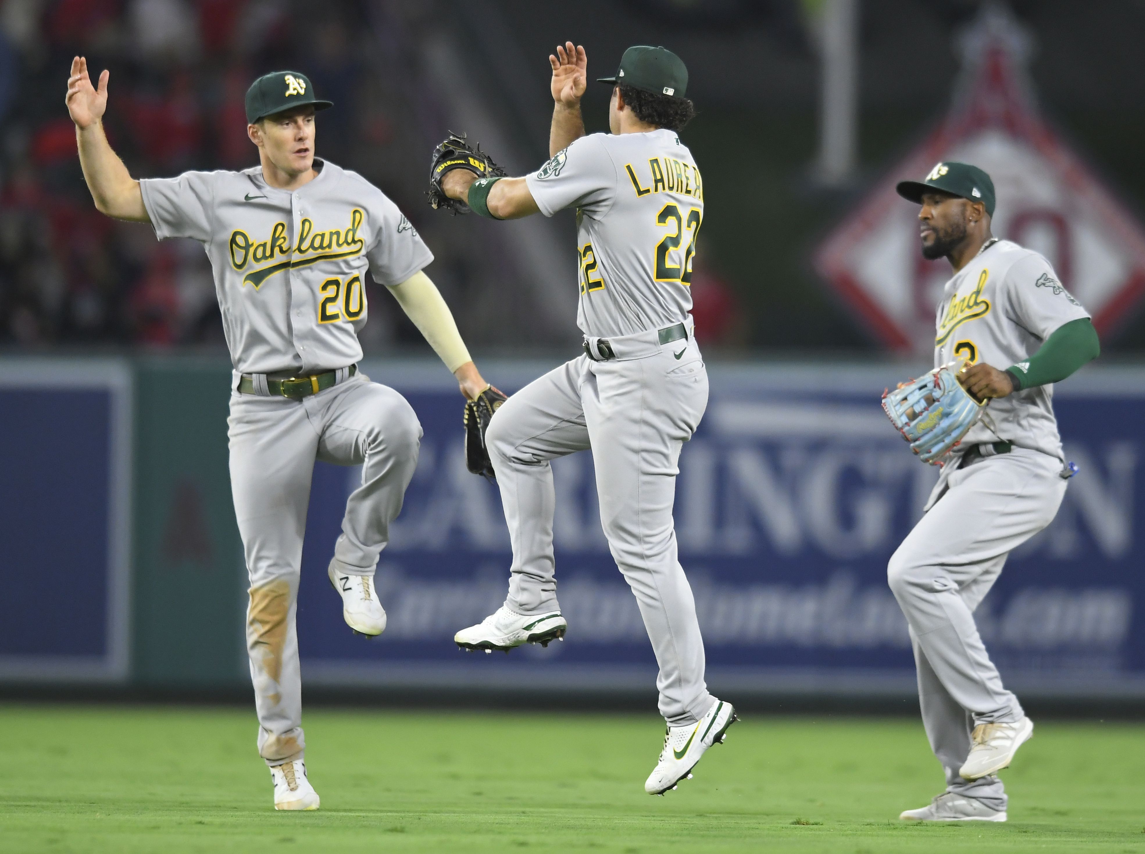 Oakland Athletics' Ramon Laureano, left, is tagged out by Houston